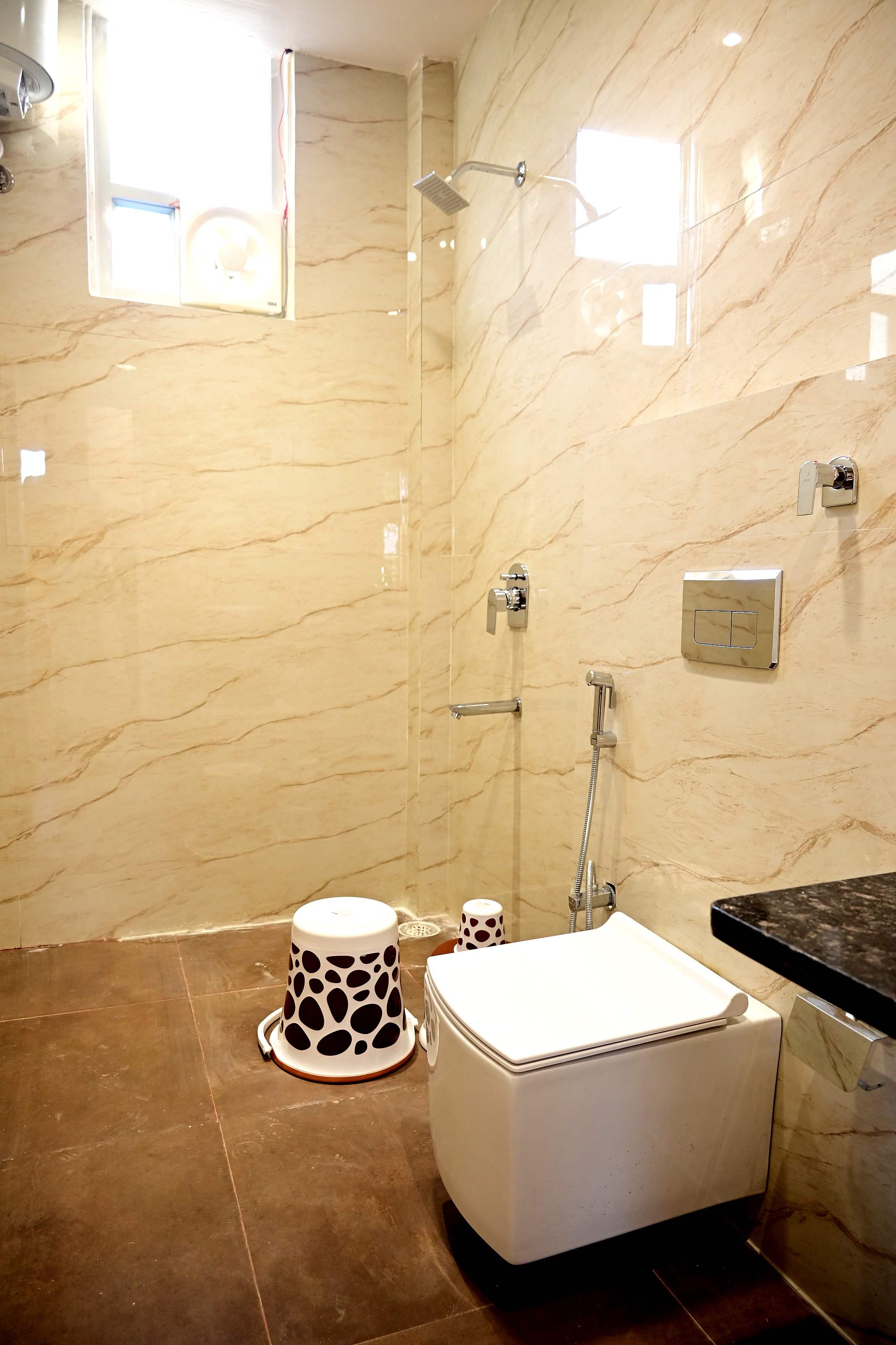 Spotless bathroom with a rain shower, glass partition and wall-mounted fittings