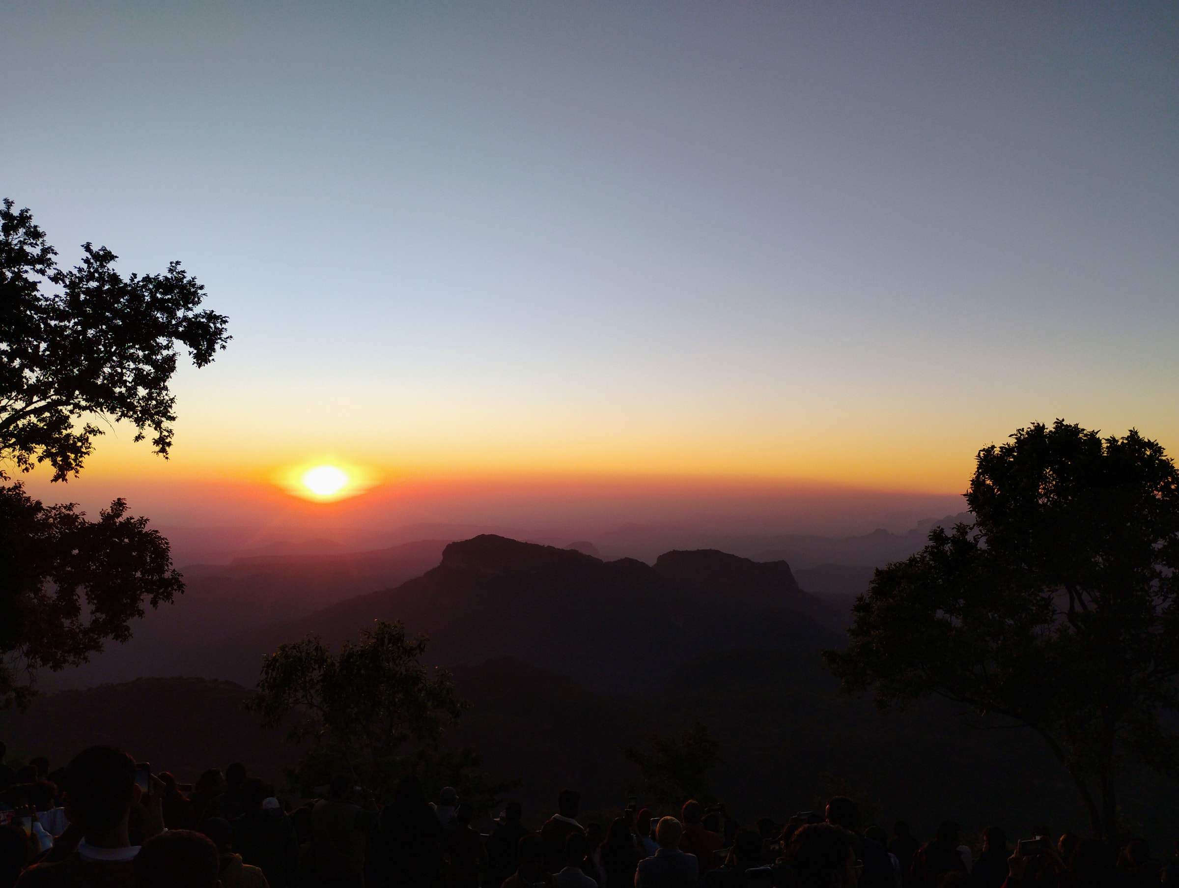 The sun setting over layered Satpura hills from a sunset point in Pachmarhi